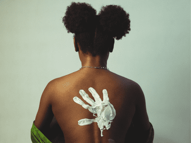 A woman with her back turned and hair in buns.