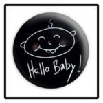 A black and white button with the words hello baby written in it.